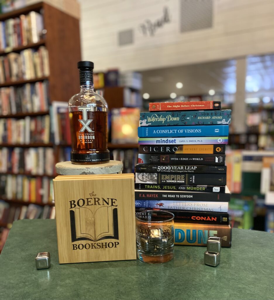 Books, Bourbon, and Wisdom – the Boerne Bookshop - the Kendall Gentleman a Bottle of Tx Bourbon Alongside a Stack of Books at the Boerne Bookshop, Symbolizing the Intersection of Knowledge, Contemplation, and Texas Spirit.