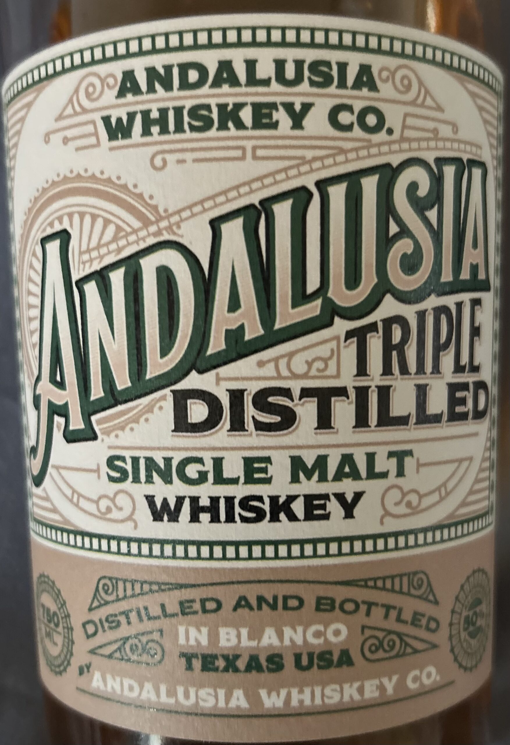 Close-up of an Andalusia Triple Distilled Single Malt Whiskey Bottle Label, Highlighting Its Texas Origin and Crafted Quality.