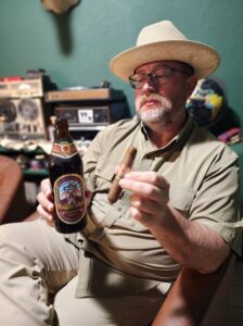 Clay Smoot, cigar reviewer for The Kendall Gentleman, relaxes with a Bajuvator Doppelbock beer and an Arturo Fuente Hemingway Short Story cigar in hand.