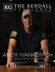 Cover of The Kendall Gentleman August 2025 issue featuring Andy Ivankovich, owner of Singing Water Vineyards, with a bottle of Freedom red wine.