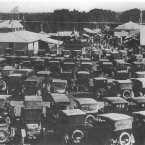 Historic photo of early 20th-century cars parked at the Kendall County Fair, representing the era of E.O. Rust.