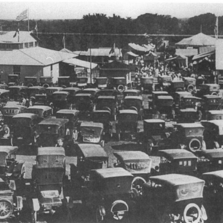 Historic photo of early 20th-century cars parked at the Kendall County Fair, representing the era of E.O. Rust.