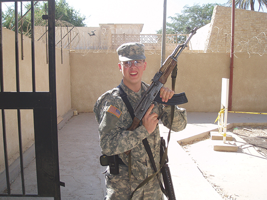 U.s. Army Combat Medic Jonathan Mallard During Deployment in Baghdad, Iraq, 2005, Photographed in Uniform Holding a Rifle.