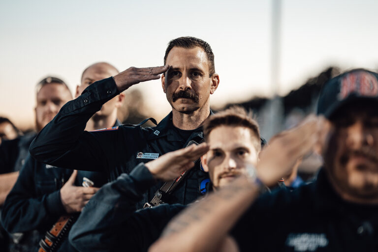 Veteran Standing in Uniform Saluting Alongside Fellow Service Members During a Ceremony, Representing Honor, Courage, and Sacrifice.