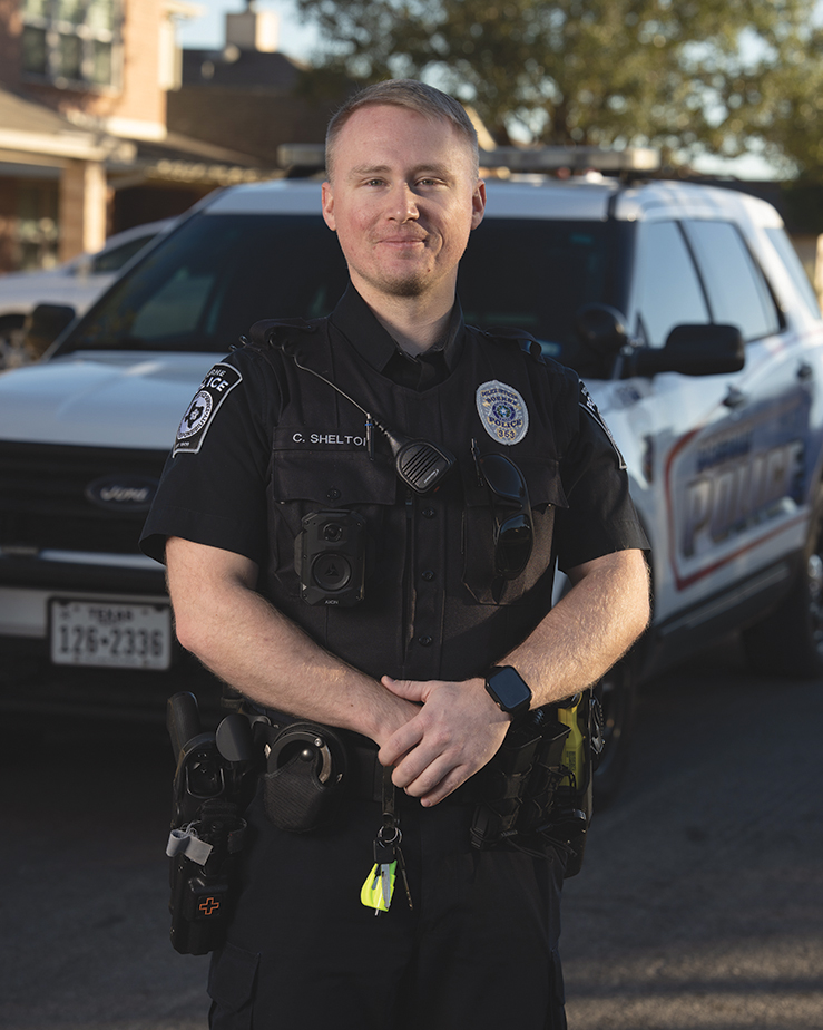 Officer Cody Shelton Standing in Uniform in Front of a Boerne Police Department Patrol Vehicle in Texas.