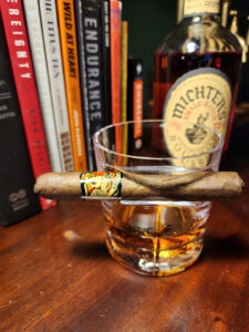 Deadwood Sweet Jane cigar resting on a glass of Michter’s Small Batch Bourbon during a February cigar review