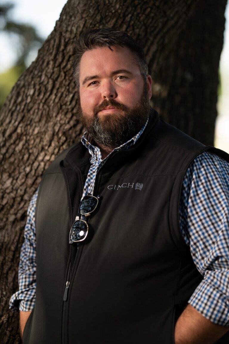 Portrait of Michael G Ethridge Standing Beside a Tree Outdoors.