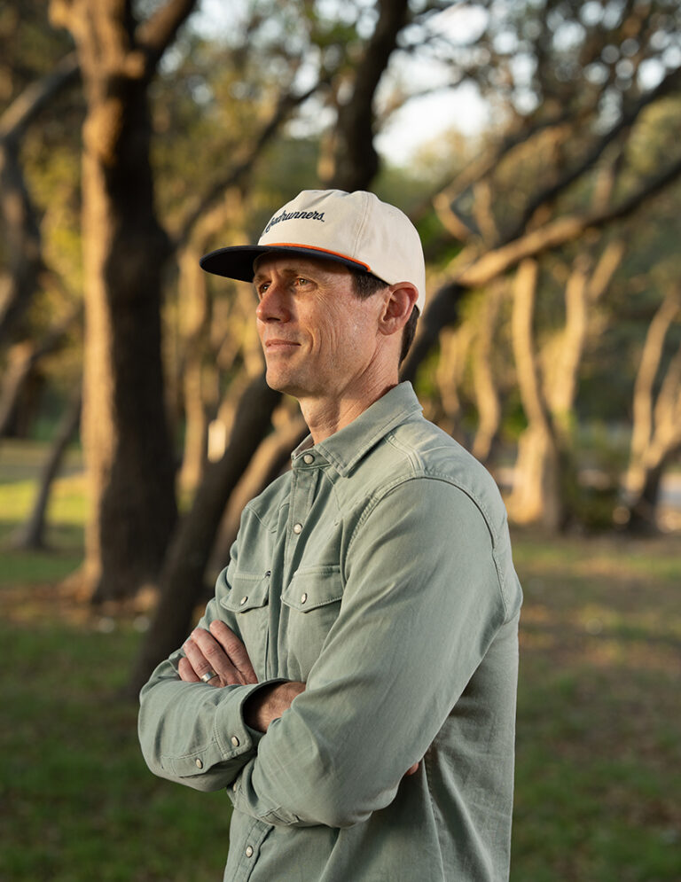 Danny Phillips Standing Outdoors in Kendall County with Oak Trees Behind Him, Reflecting on Faith, Family Roots, and Vocation