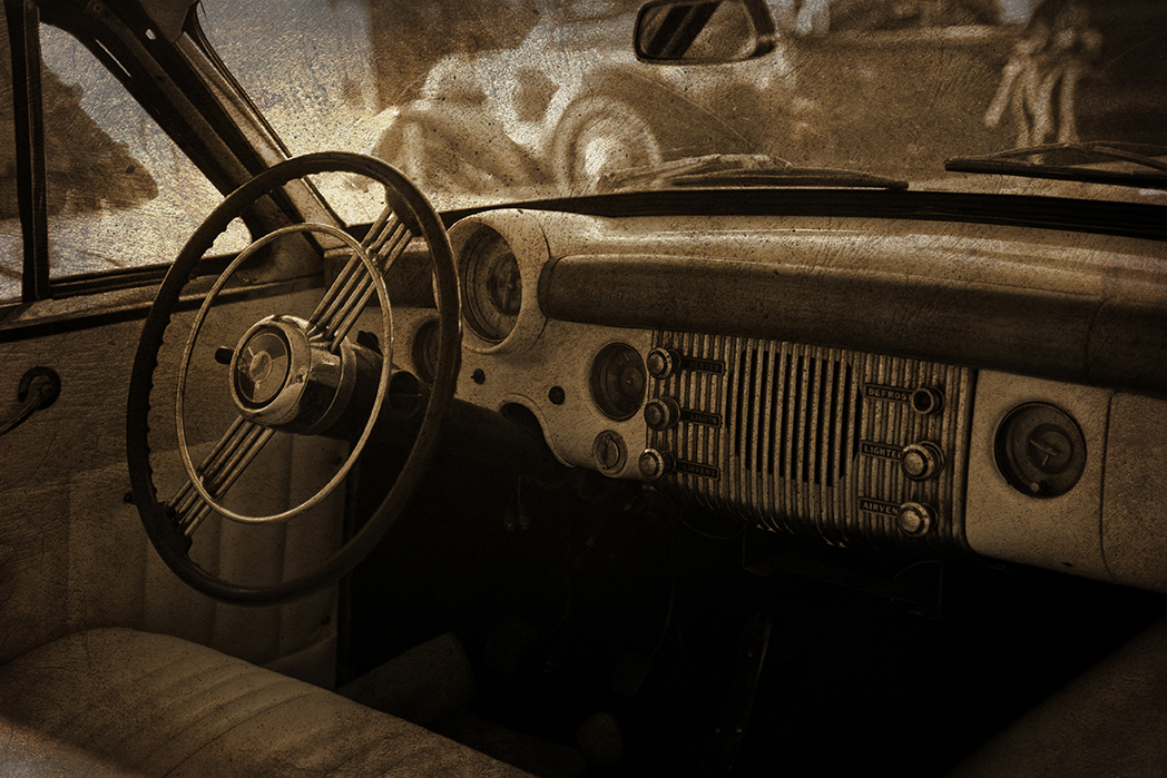 Sepia-toned Interior of a Vintage Buick Automobile with Worn Dashboard and Steering Wheel, Evoking Memories of Early Boerne, Texas and Small-town Life in Kendall County.