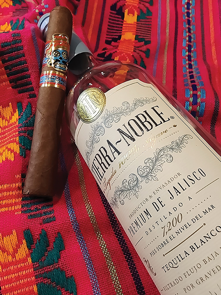 Cinco De Mayo Limited Edition Cigar Paired with a Bottle of Tierra-noble Tequila on a Colorful Mexican Serape Blanket, Celebrating South Texas and Mexican Culture.