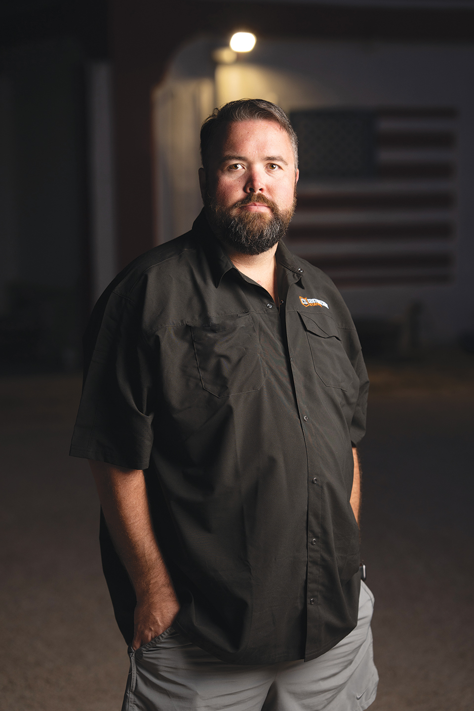 Michael G Ethridge, Publisher of the Kendall Gentleman, Portrait with American Flag Backdrop