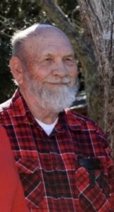 John Eddie Vogt in a Red Plaid Shirt Beside a Tree