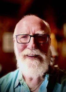 Tom Allred in Glasses and a Light Blue Shirt