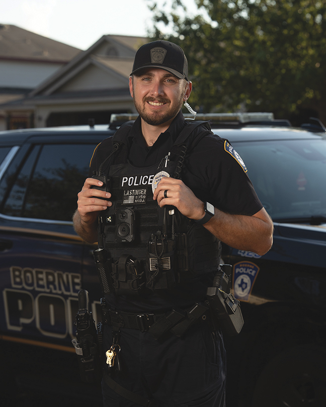 Boerne Police Officer Brady Lastinger in Uniform Standing in Front of a Boerne Police Patrol Vehicle